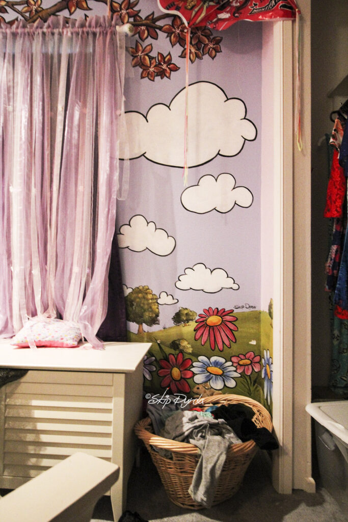 Photo of a young ladies bedroom where I painted flowers, trees, bumblebees and a tree.