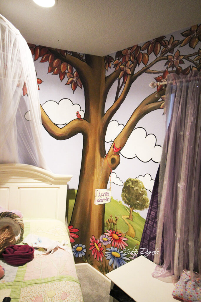 Photo of a young ladies bedroom where I painted flowers, trees, bumblebees and a tree.