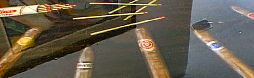 A detail photo of a round coffee table on which I painted Trompe L'oeil cigars