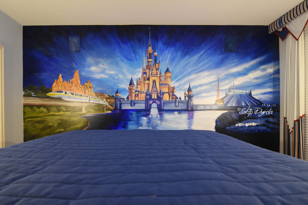 A photo of a mural I painted in a condo on Longboat Key, FL. The mural is a sort of fictional landscape of DisneyWorld.