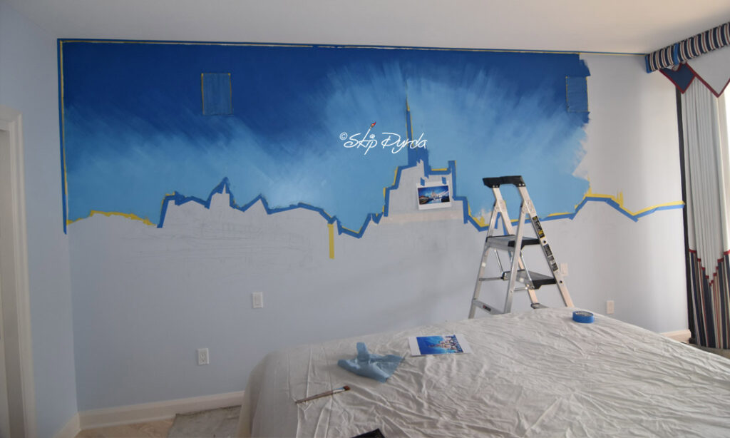 A photo of a mural I painted in a condo on Longboat Key, FL. The mural is a sort of fictional landscape of DisneyWorld. In Progress 1