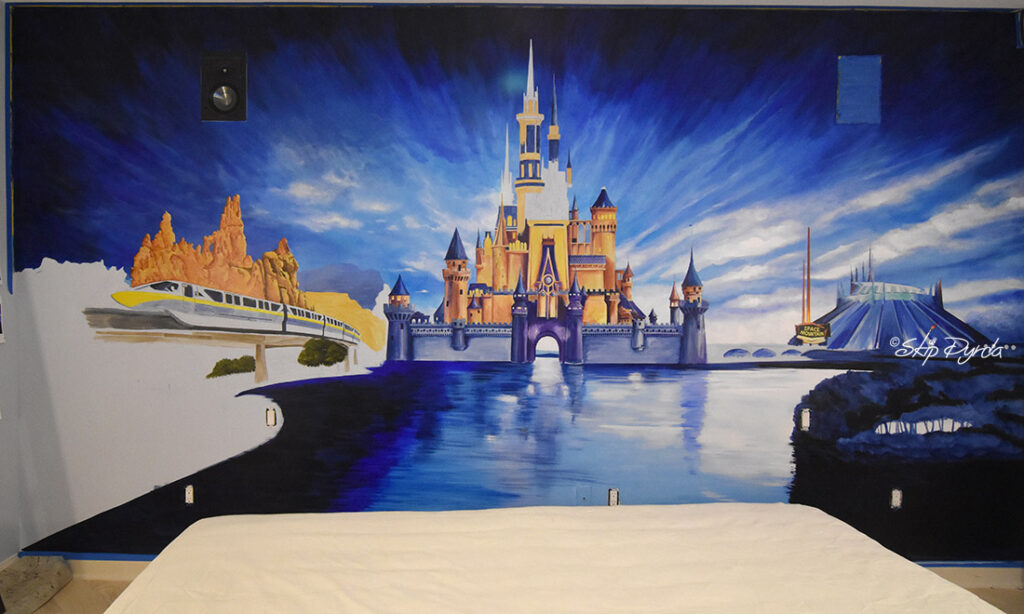A photo of a mural I painted in a condo on Longboat Key, FL. The mural is a sort of fictional landscape of DisneyWorld. In Progress 3