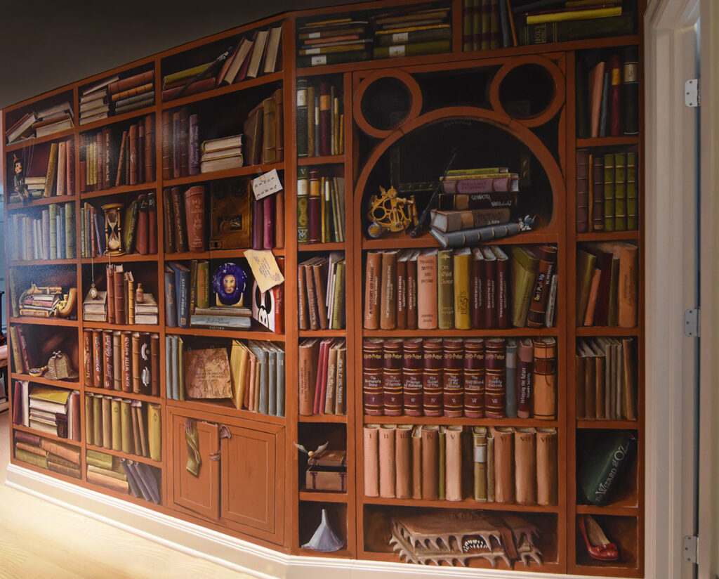 A photo of a mural painted to look like a home library, by Skip Dyrda