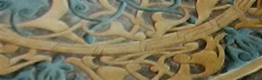 Detail photo of a large round stone table that I painted with an ornate Mayan design