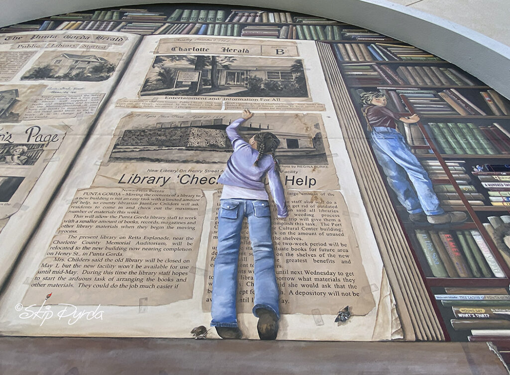 Photo of a mural I painted on a library in Punta Gorda, FL that showcases the history of the libraries system in PG