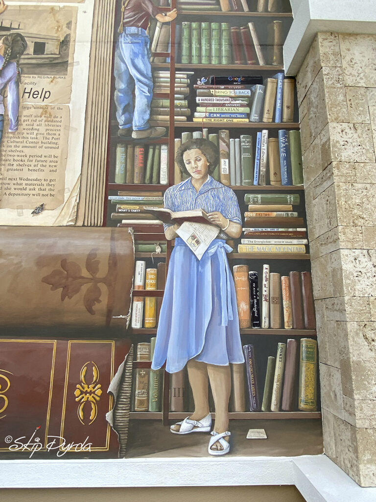 Photo of a mural I painted on a library in Punta Gorda, FL that showcases the history of the libraries system in PG