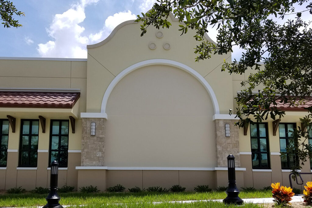Photo of a mural I painted on a library in Punta Gorda, FL that showcases the history of the libraries system in PG