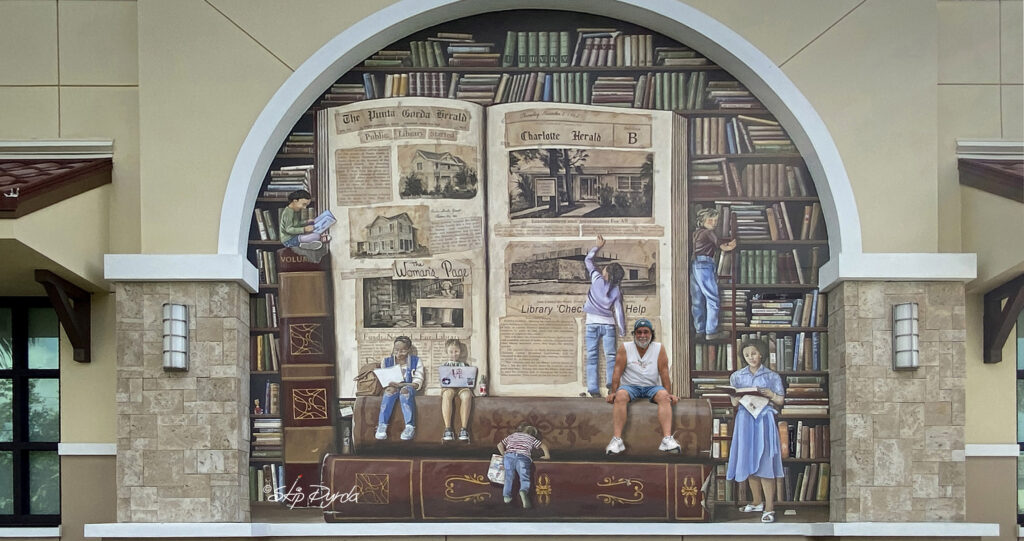 Photo of a mural I painted on a library in Punta Gorda, FL that showcases the history of the libraries system in PG