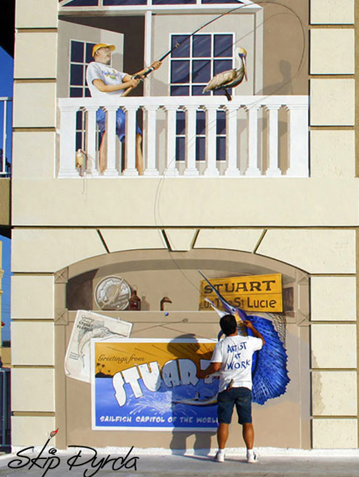 A photo of Skip Dyrda painting a mural in Stuart, FL