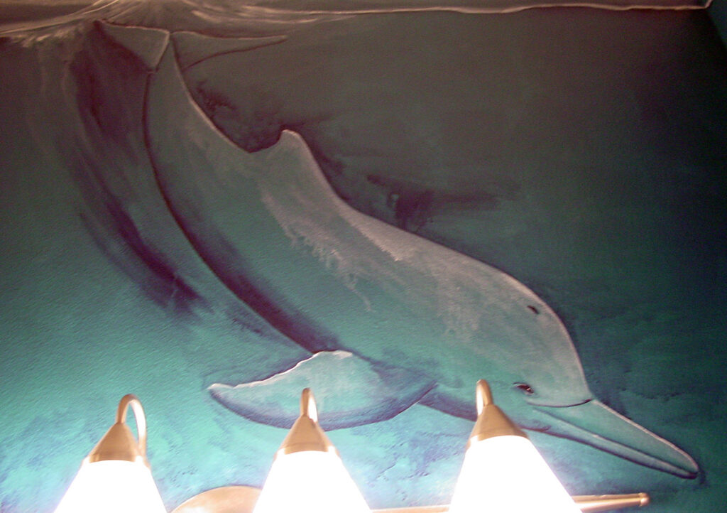 Photo of an underwater scene mural I painted on 3 walls inside of the pool powder room in DIck Vitales house.