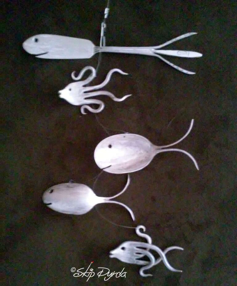 A photo of a mobile of fish, all made from stainless steel flatware