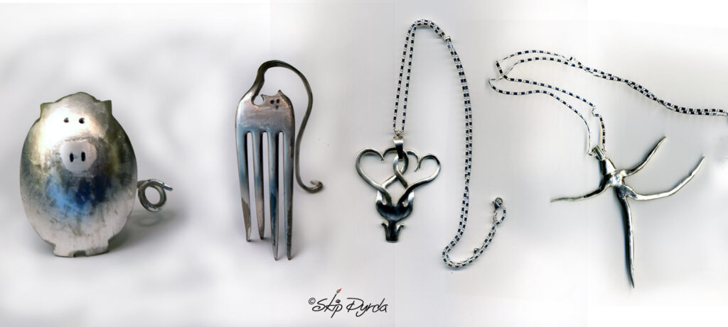 A photo of four pieces of stainless or silver flatware made into jewelry and figurines