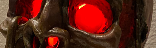 A photo of a pirate skull lamp that I created out of plastic clay and various found parts.