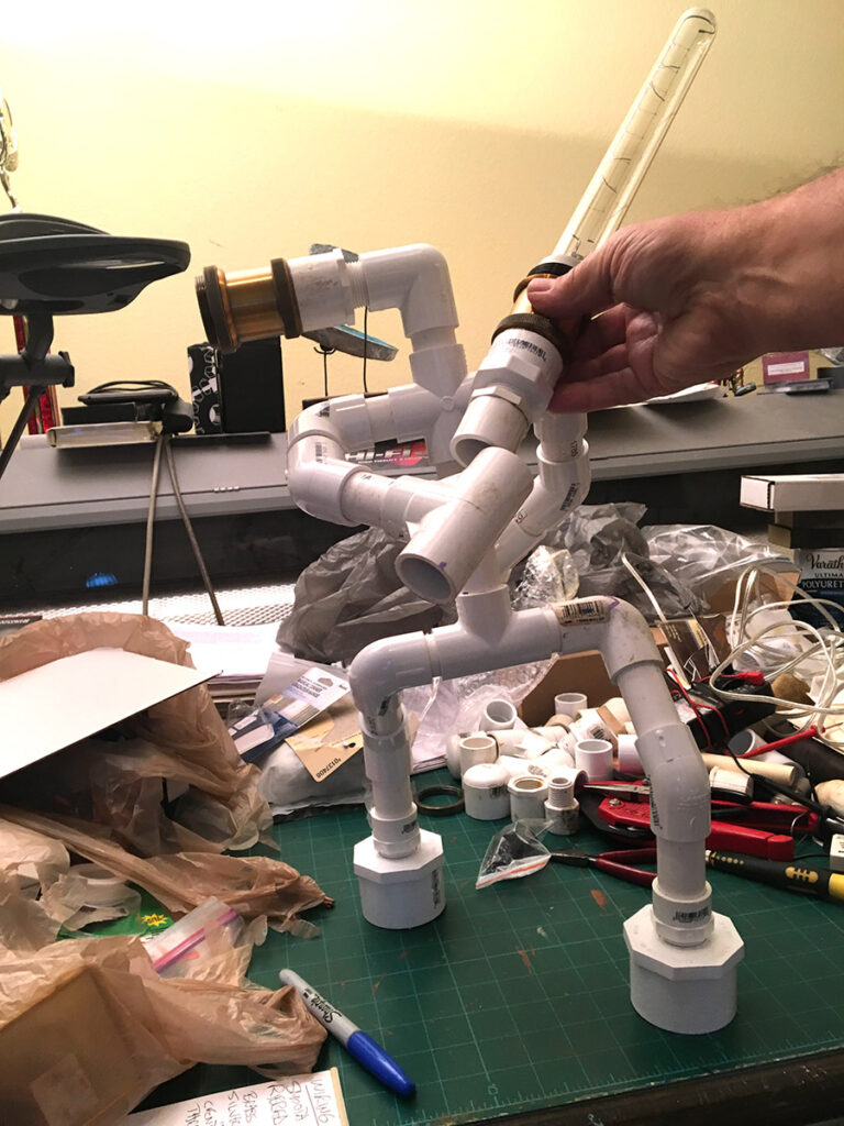 Custom made tablelamp, made to look like a fighting robot made of waterpipe