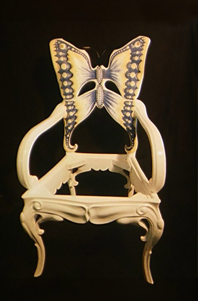 A photo of a carved chair made to look like a butterfly. I painted the details.