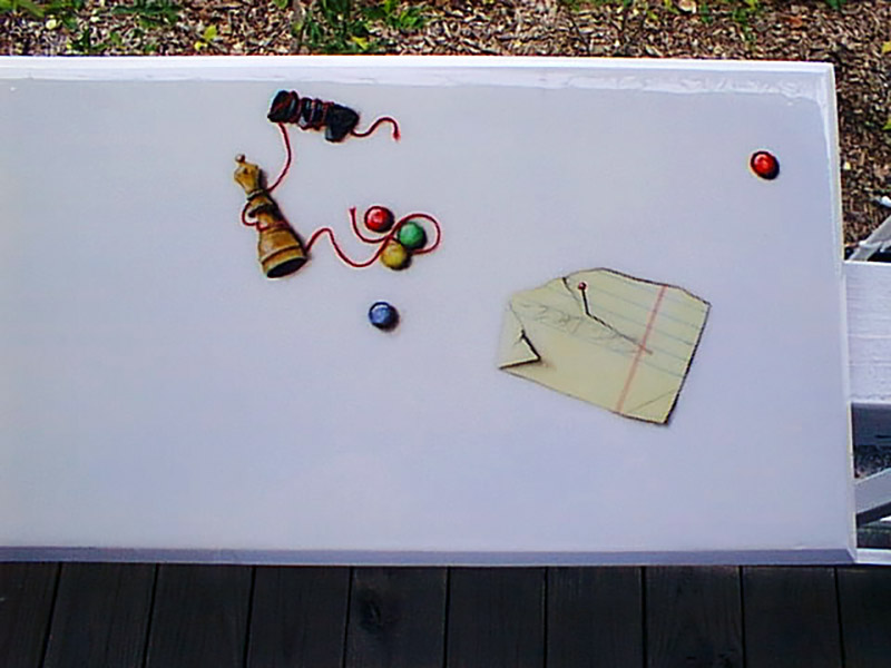 A detail photo of a sofa table on which I painted various game pieces and a hand written note.